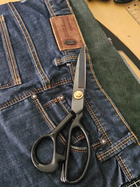 Reclaimed denim bag pieces prepared for sewing, showing the structure and careful construction behind Gabus81 denim bags.