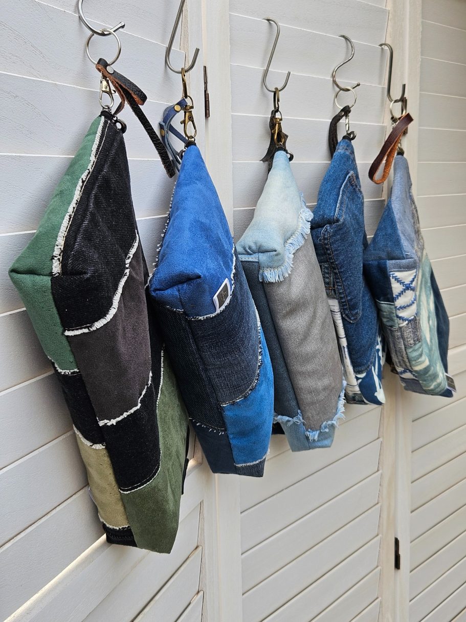 Denim Organisers Small batch of handmade denim pouches hanging together as everyday bag organisers