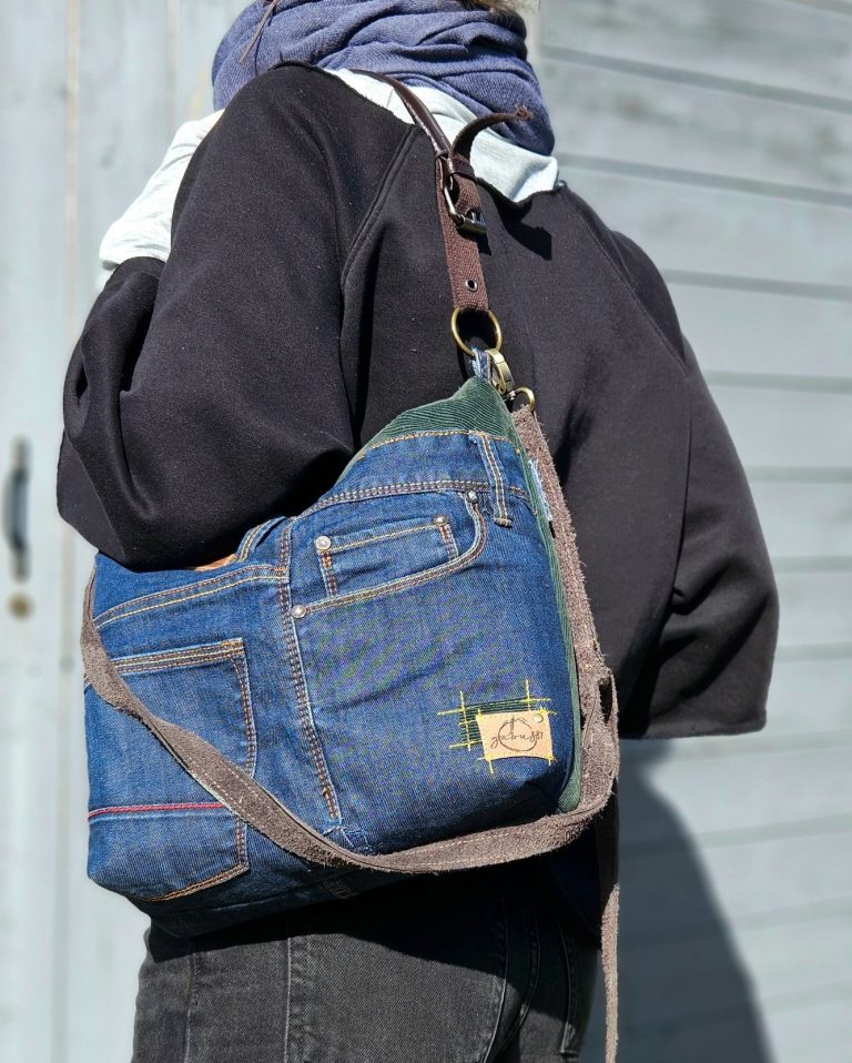Denim crossbody bag made from reclaimed jeans worn over the shoulder