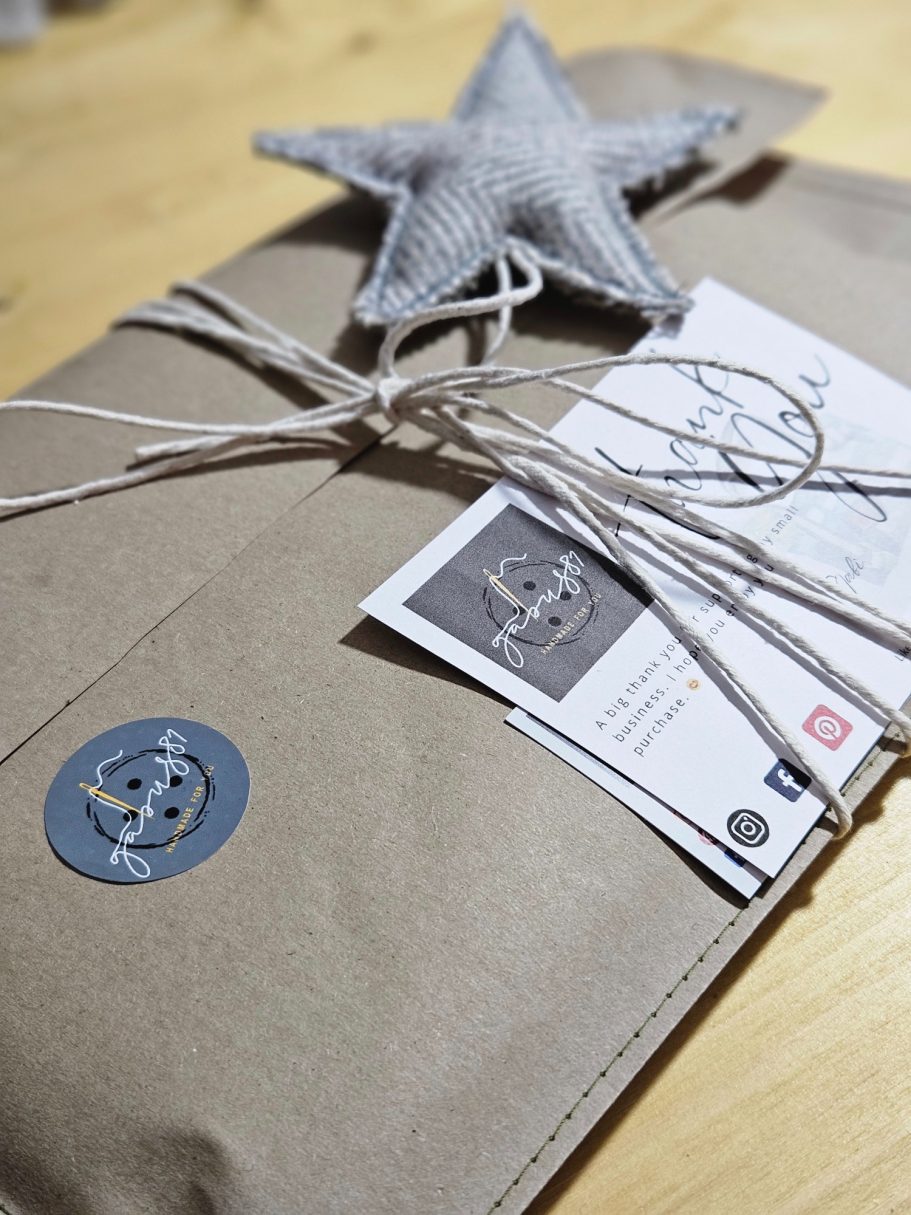 Gift Wrapping Details Eco-friendly gift wrapping with brown paper, string and a handwritten thank you card.
