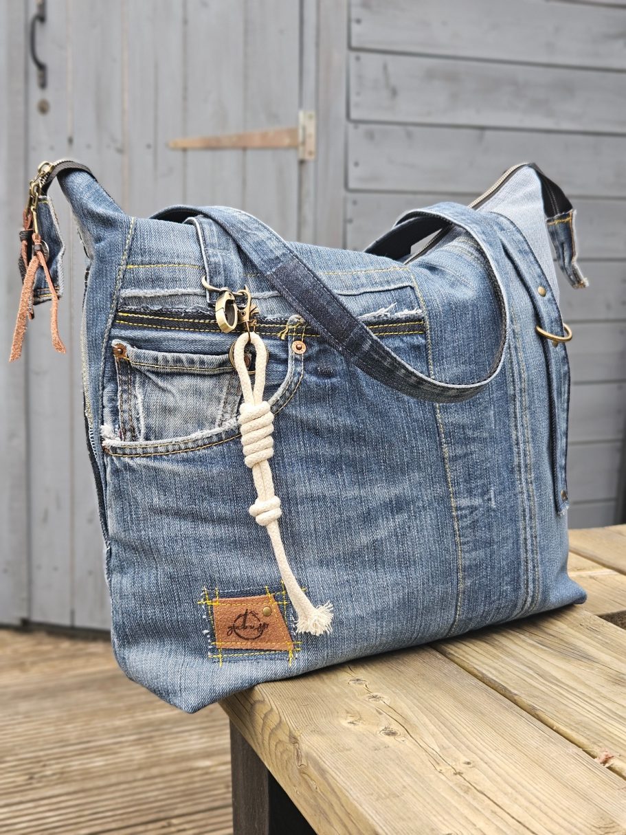Denim Tote Bag Handmade reclaimed denim tote bag shown from the side, with zip detail, textured denim panels and leather Gabus81 label.